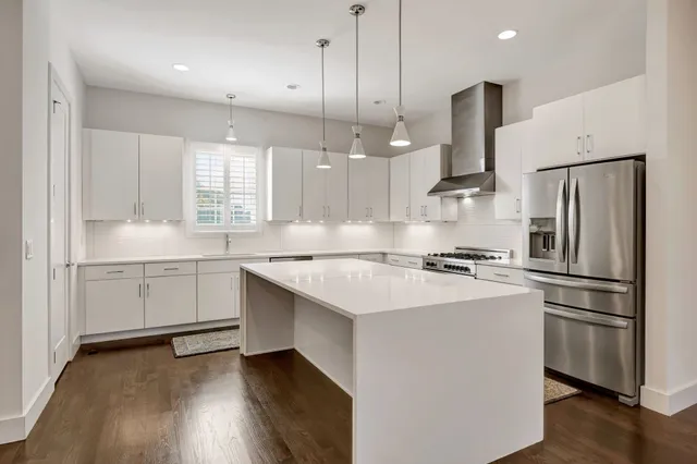 a kitchen with white cabinets and white stainless steel appliances