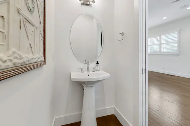 a bathroom with a sink a mirror and shower