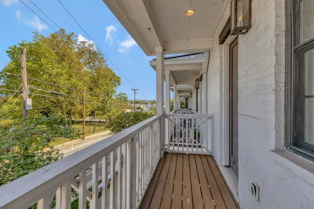 a view of a balcony with wooden floor