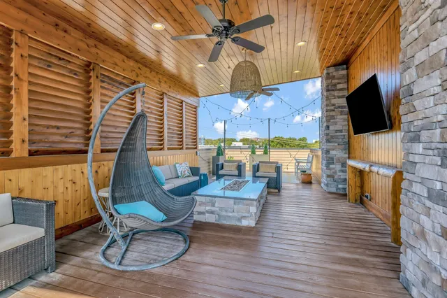 a living room with fireplace furniture and a flat screen tv