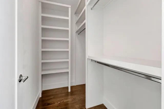 a view of walk in closet with empty racks