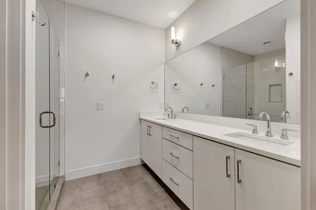 a bathroom with a double vanity sink and mirror