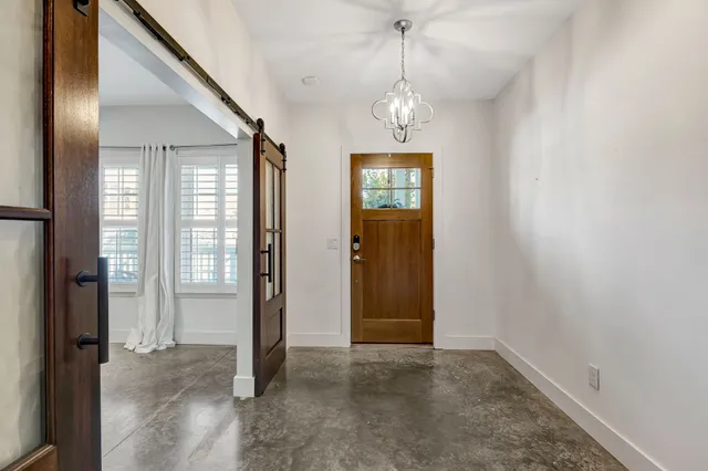 an empty room with windows and entryway