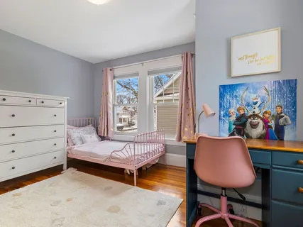 a bedroom with furniture and a window