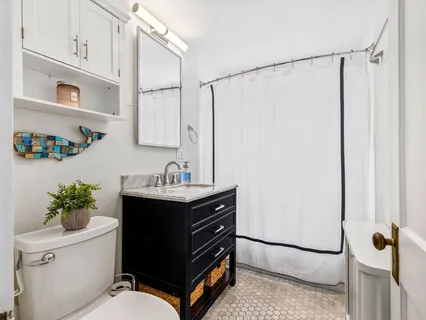 a bathroom with a sink toilet and shower