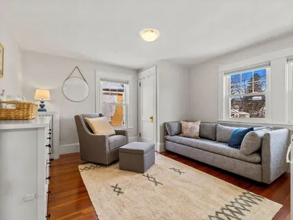 a living room with furniture a rug and a window
