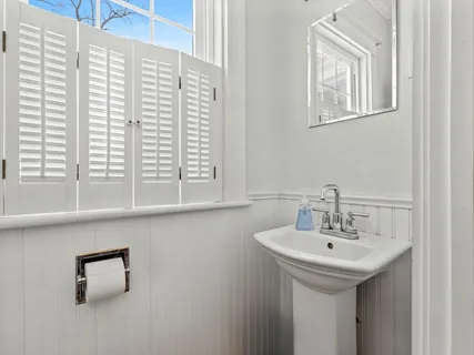 a bathroom with a sink and a window