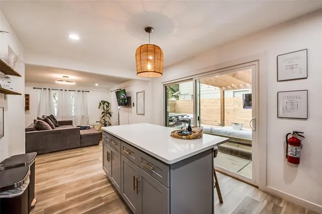 a large kitchen with kitchen island a large counter space windows and appliances