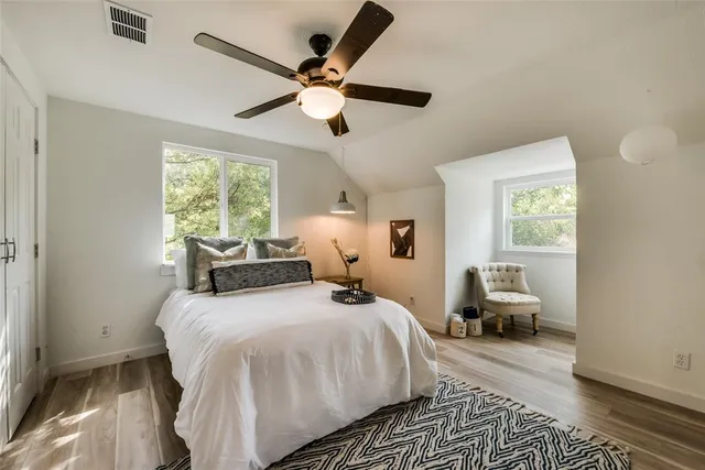 a bedroom with a bed and wooden floor