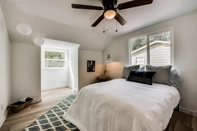 a bedroom with a large bed and a window