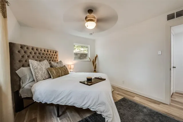 a bedroom with a bed and painting on the wall