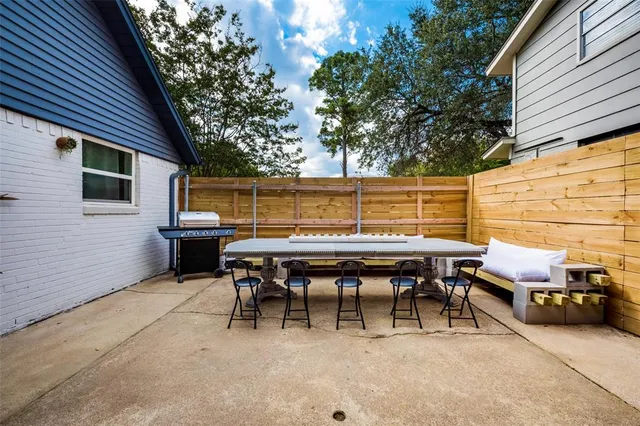 a backyard of a house with outdoor seating