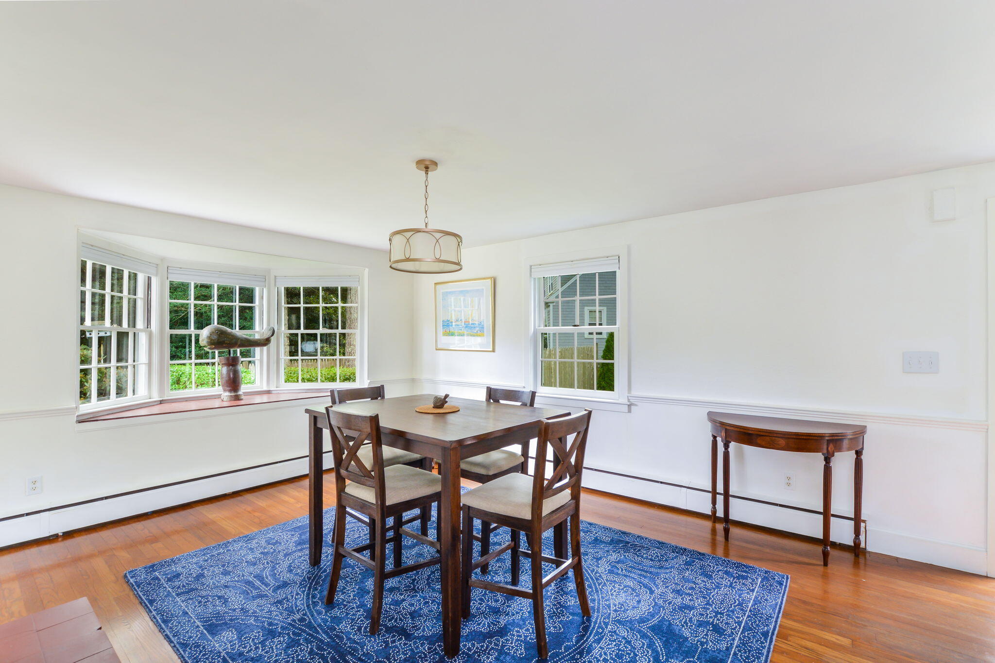 141 Pond View Drive Centerville, MA 02632 - Photo 18 of 44 a view of a dining room with furniture window and wooden floor