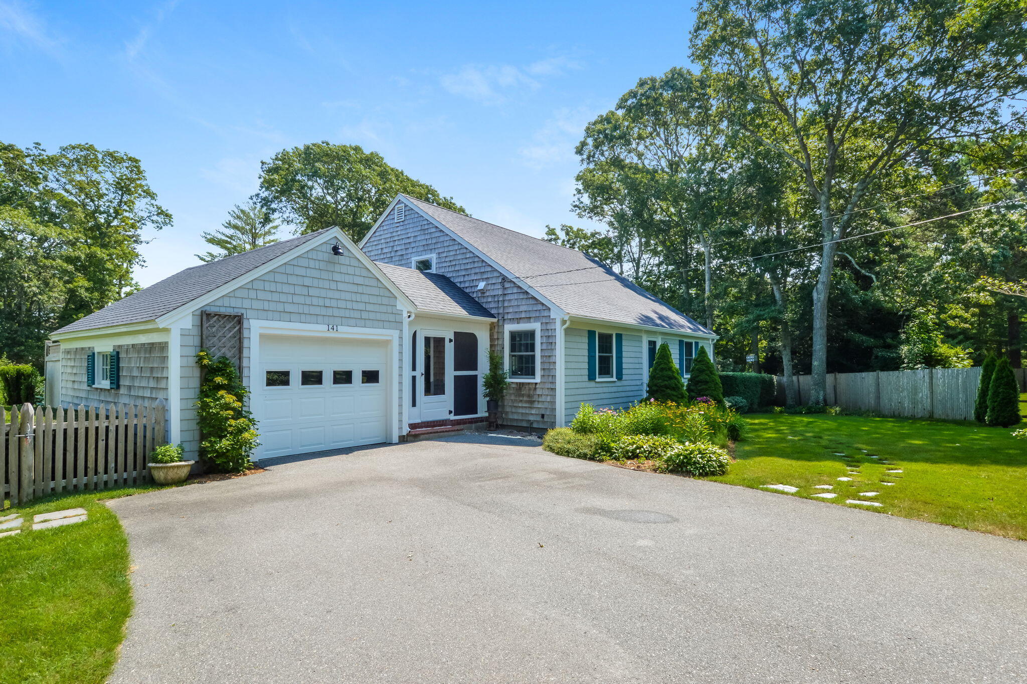 141 Pond View Drive Centerville, MA 02632 - Photo 2 of 44 a front view of a house with garden
