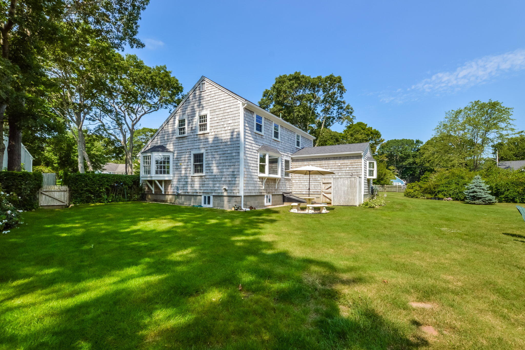 141 Pond View Drive Centerville, MA 02632 - Photo 5 of 44 a view of a house with a big yard plants and large trees