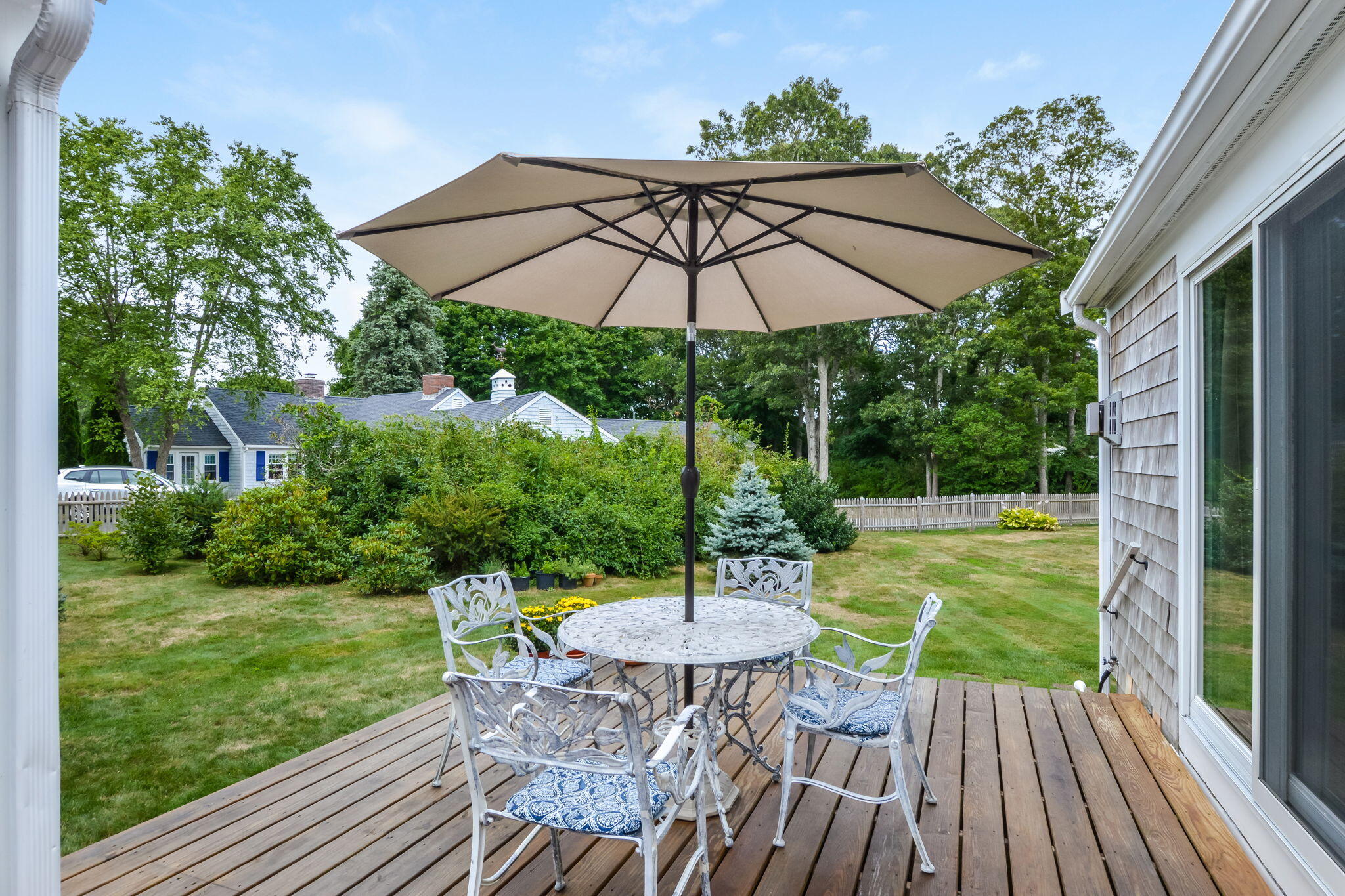 141 Pond View Drive Centerville, MA 02632 - Photo 10 of 44 a view of a chair and table on the deck