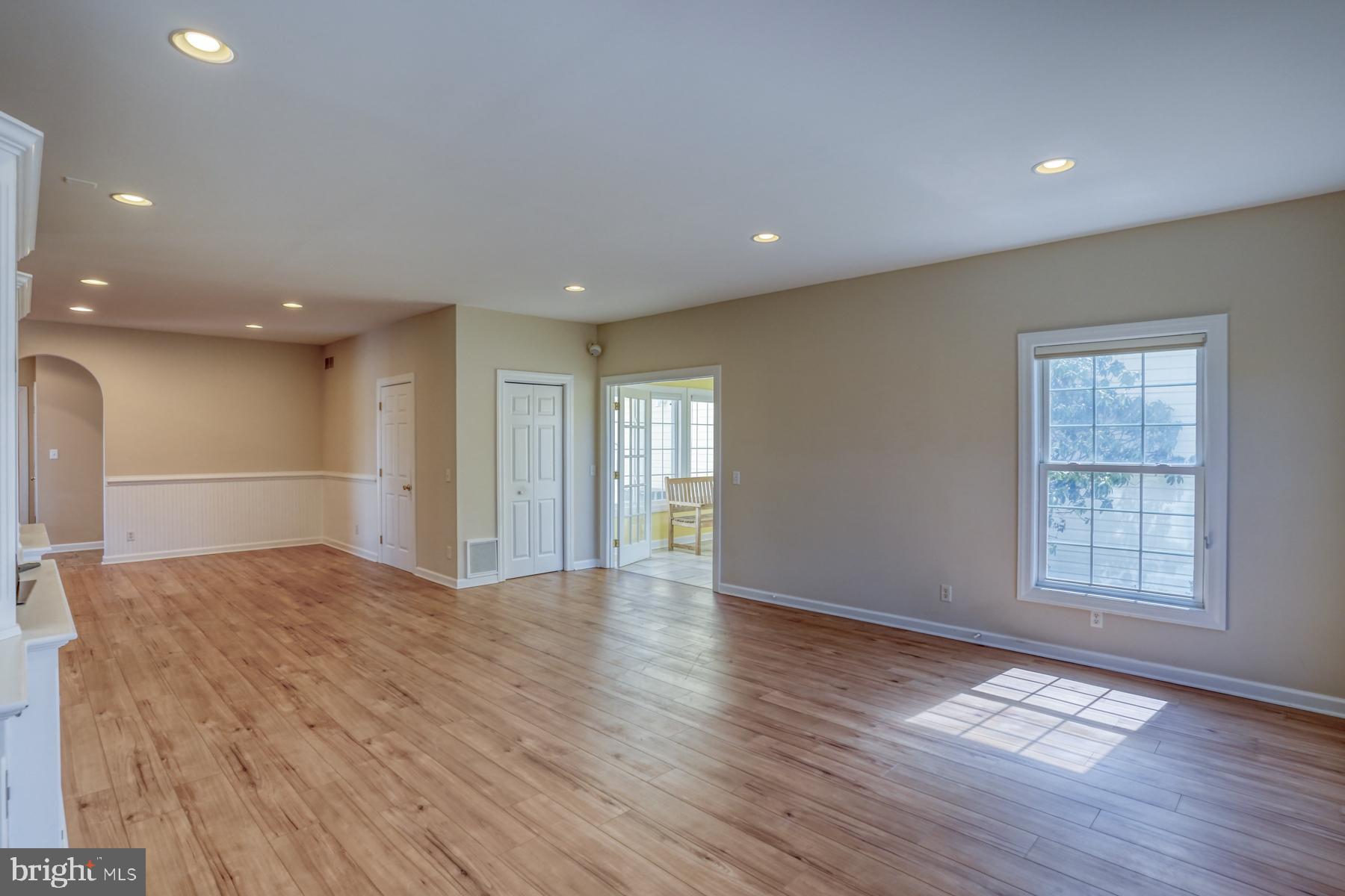 18605 Road 255 Georgetown, DE 19947 - Photo 17 of 93 a view of an empty room with wooden floor and a window