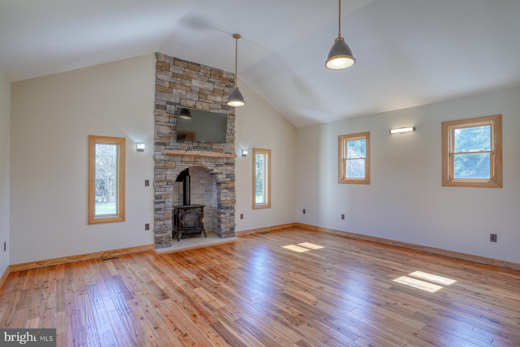 18605 Road 255 Georgetown, DE 19947 - Photo 35 of 93 a view of an empty room with wooden floor fireplace and a window