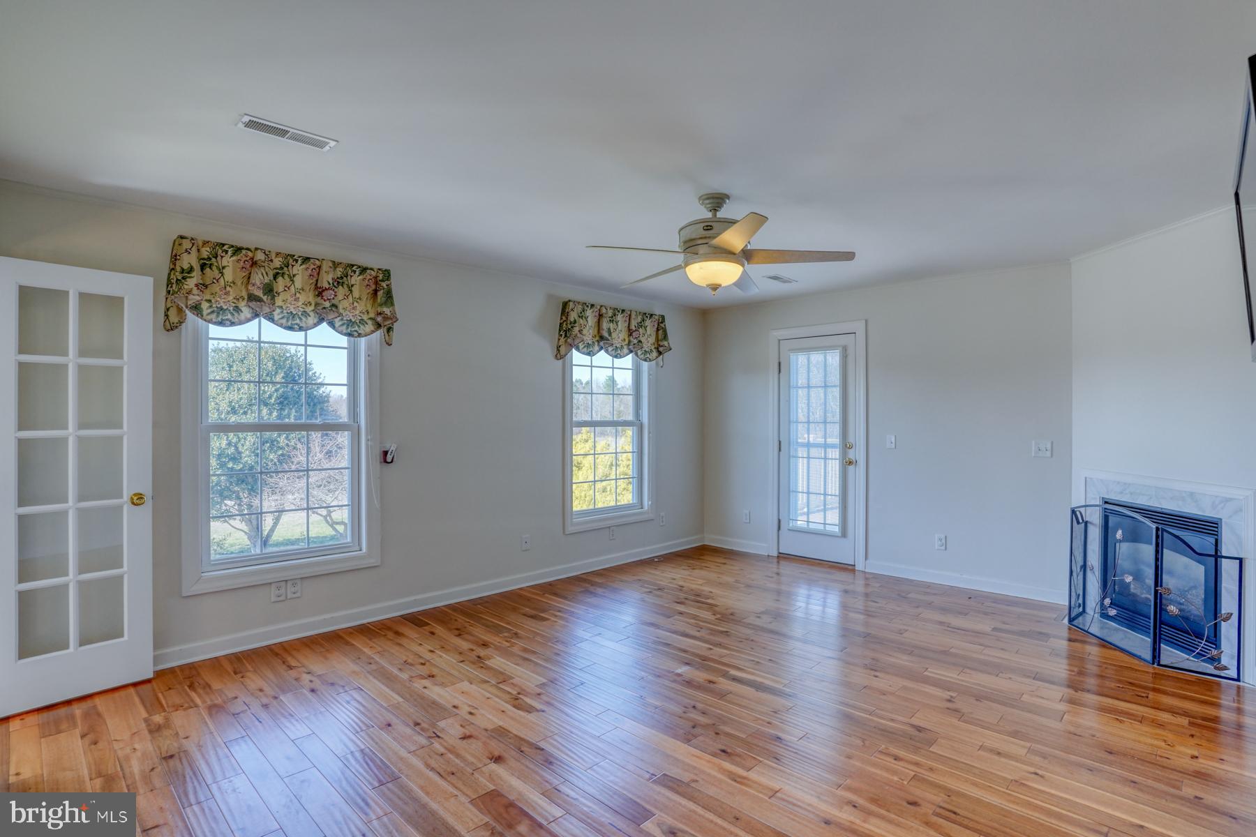 18605 Road 255 Georgetown, DE 19947 - Photo 54 of 93 an empty room with wooden floor and windows