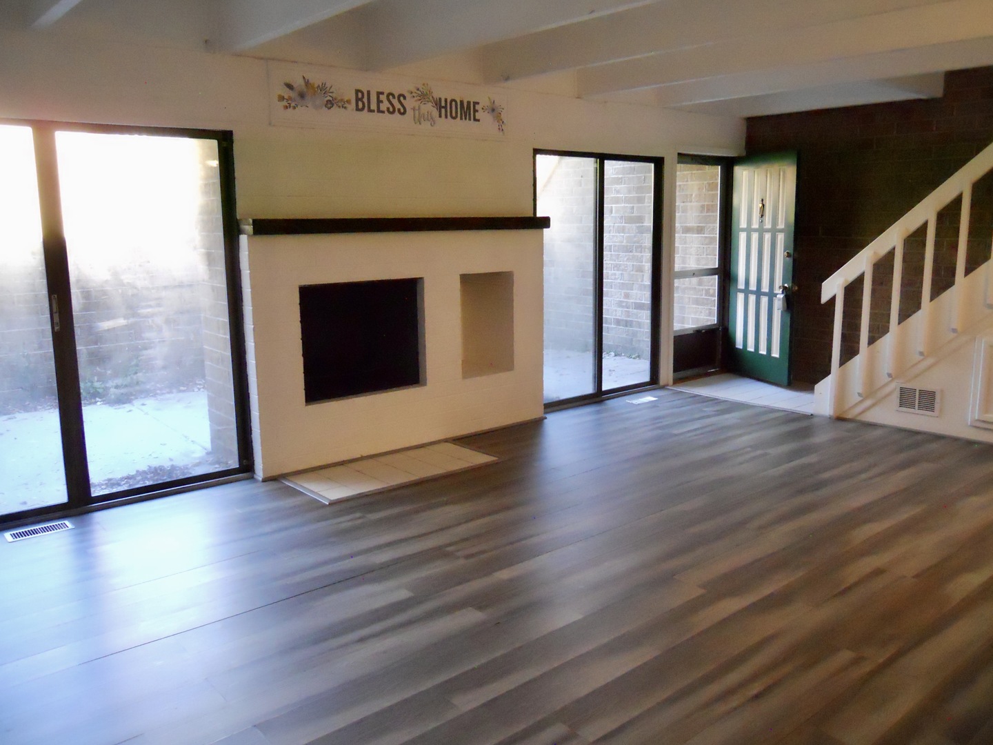 508 Kenneth Circle Elgin, IL 60120 - Photo 2 of 19 a view of an empty room with wooden floor and a window