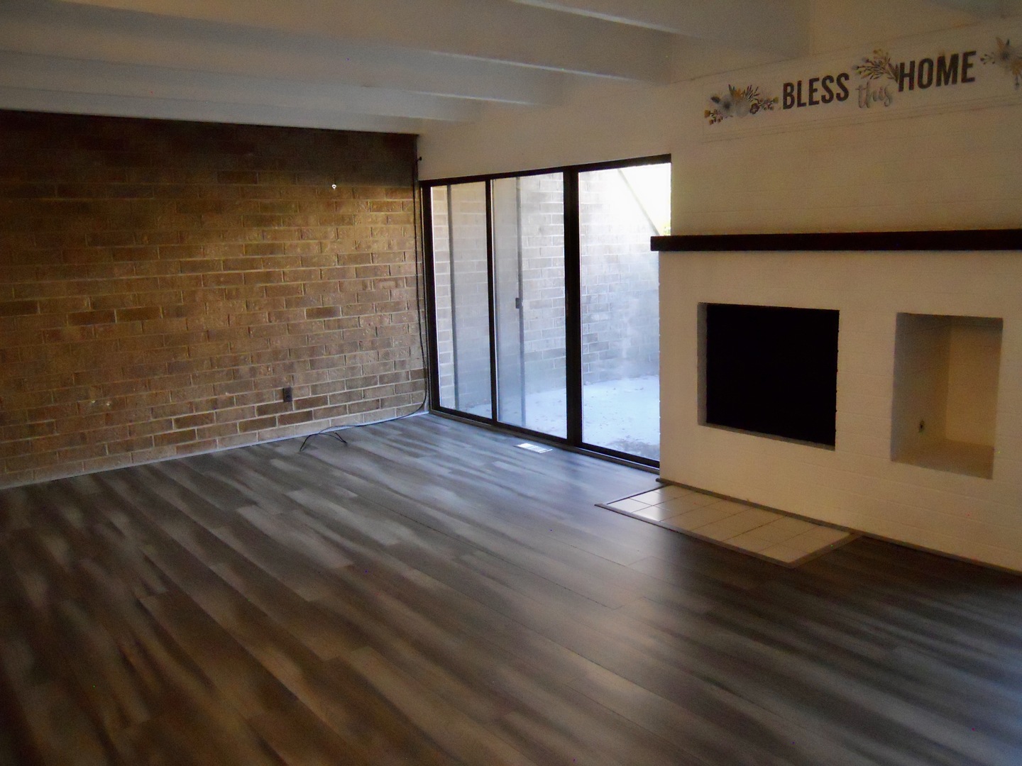 508 Kenneth Circle Elgin, IL 60120 - Photo 3 of 19 a view of an empty room with wooden floor and a window