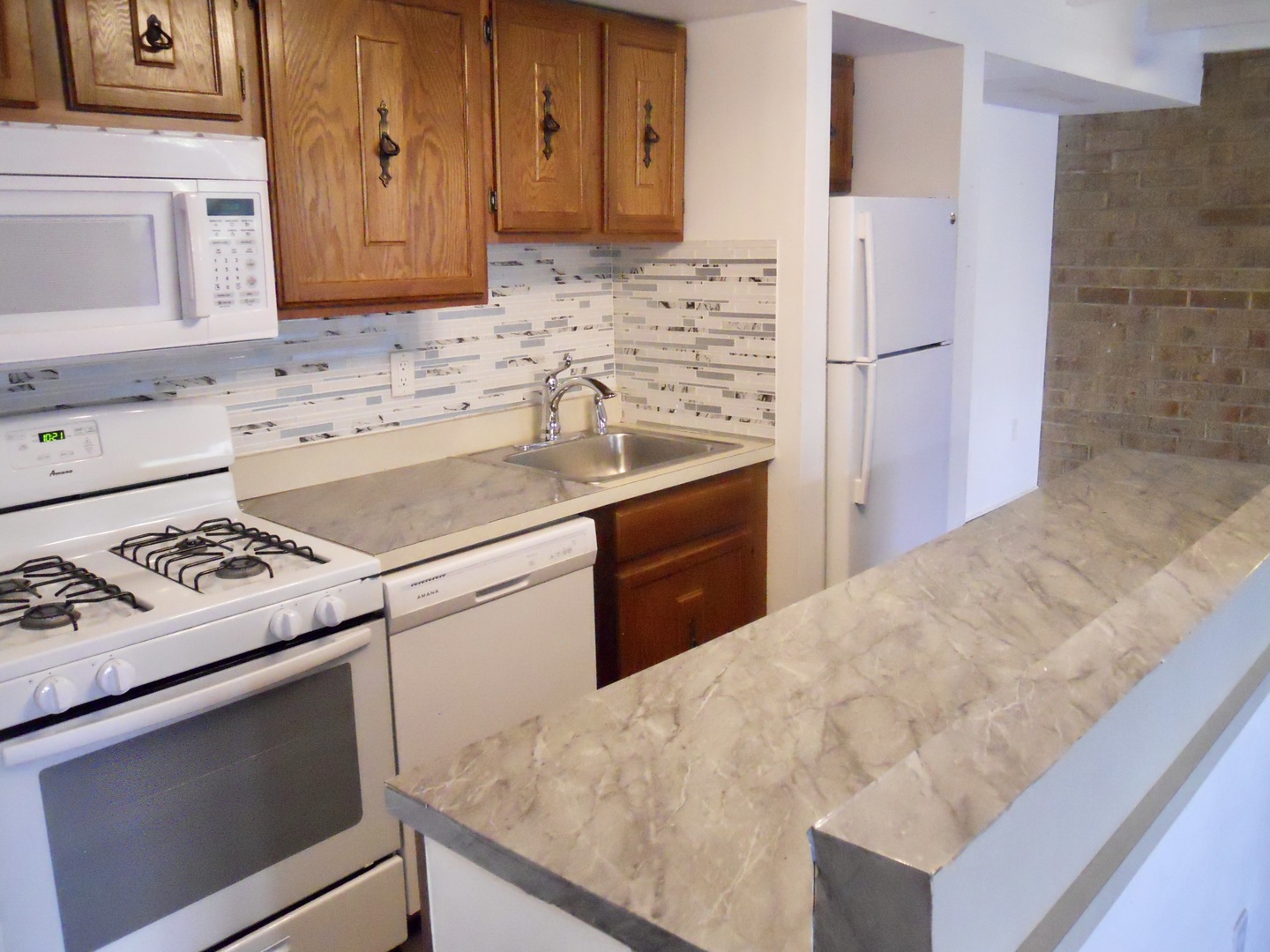 508 Kenneth Circle Elgin, IL 60120 - Photo 6 of 19 a kitchen with a sink stove and refrigerator