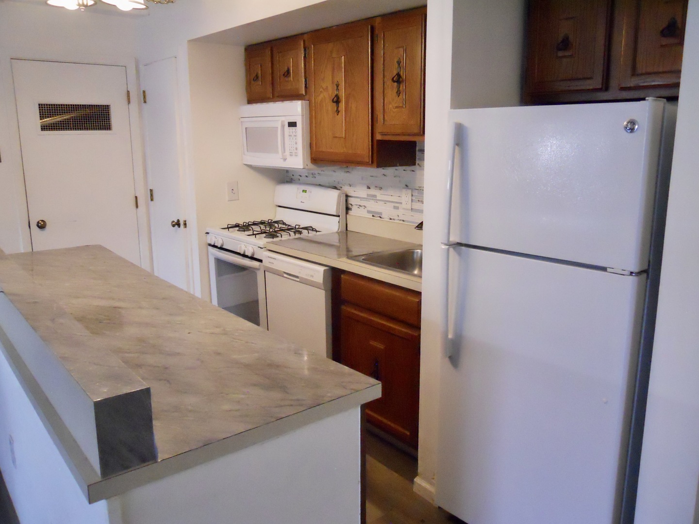 508 Kenneth Circle Elgin, IL 60120 - Photo 7 of 19 a white refrigerator freezer and a stove sitting inside of a kitchen