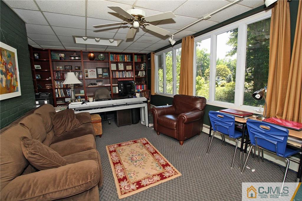 40 Stafford Road Colonia, NJ 07067 - Photo 14 of 25 a living room with furniture a ceiling fan and a large window