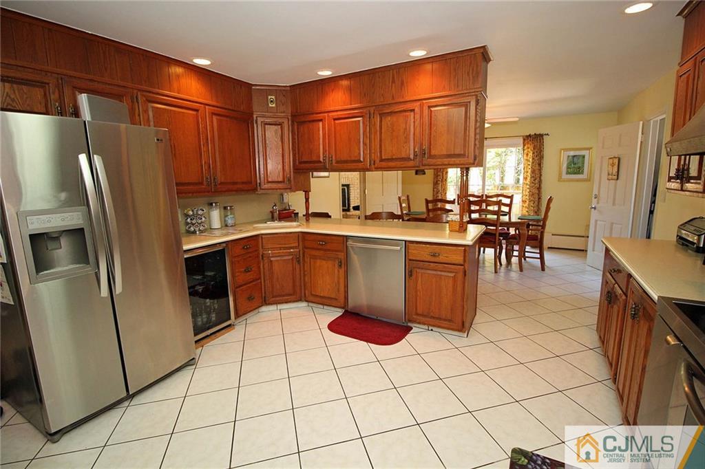 40 Stafford Road Colonia, NJ 07067 - Photo 17 of 25 a kitchen with stainless steel appliances a stove a sink a microwave and a refrigerator