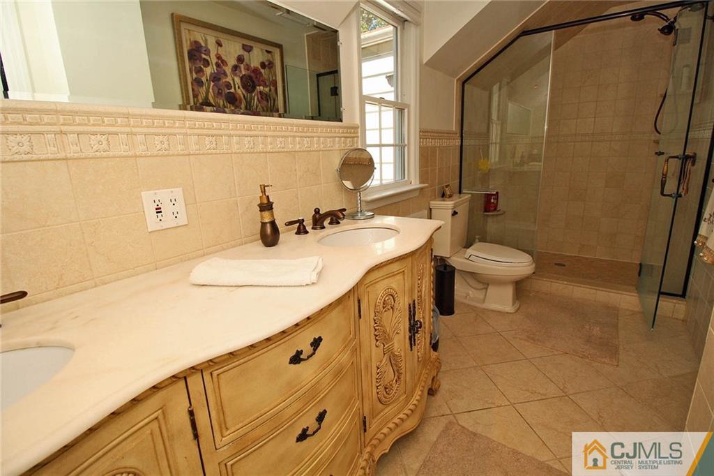40 Stafford Road Colonia, NJ 07067 - Photo 21 of 25 a bathroom with a sink a toilet and shower