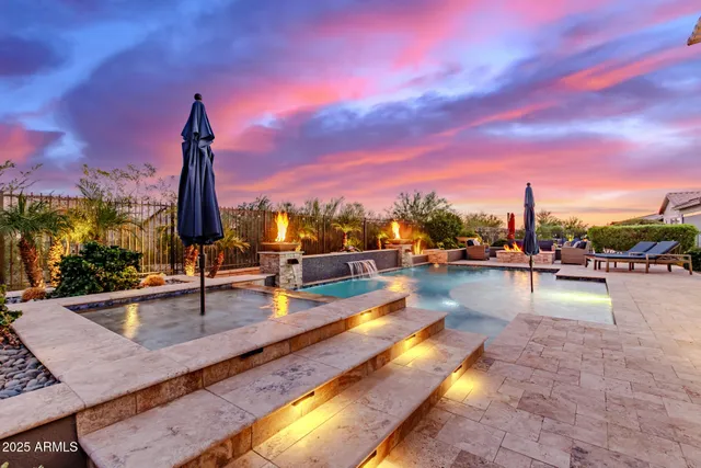 a view of a swimming pool with couches and city view