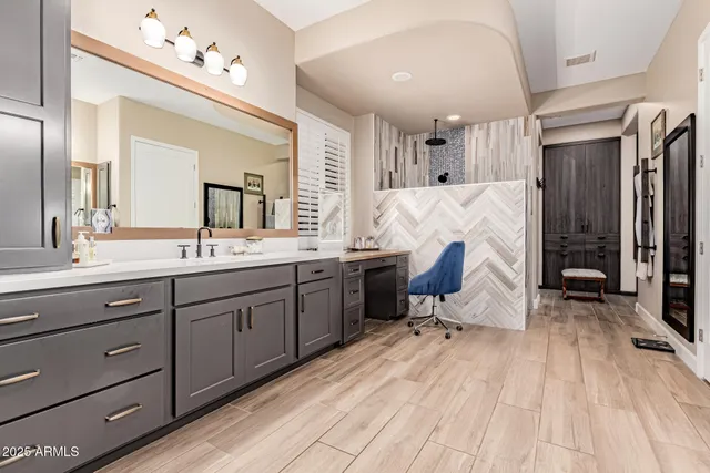 a spacious bathroom with a double vanity sink and a mirror