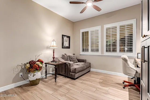 a bedroom with furniture and a large window