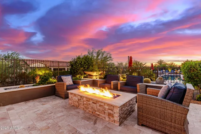 a view of a roof deck with couches and sky view