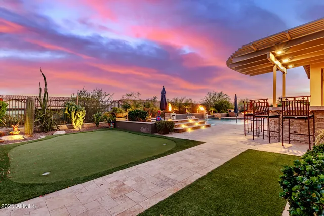 a view of a patio with a table and chairs and potted plants