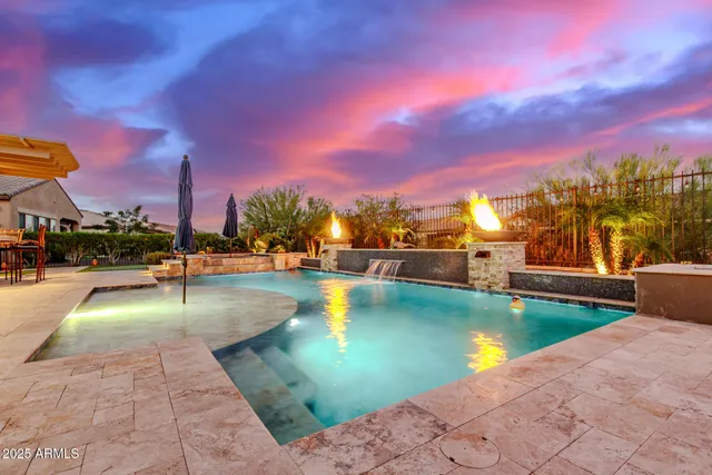 a view of a swimming pool with a table and chairs