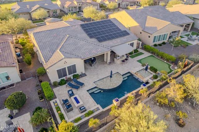 an aerial view of residential house with outdoor space and parking