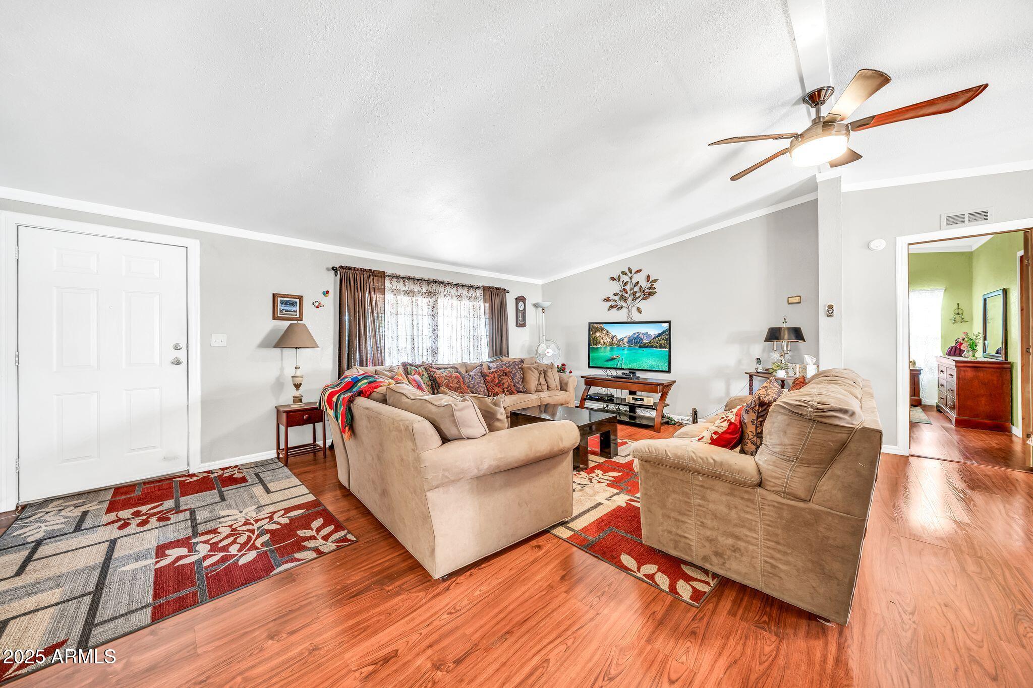 2510 East Utopia Road Phoenix, AZ 85050 - Photo 10 of 31 a living room with furniture and a wooden floor