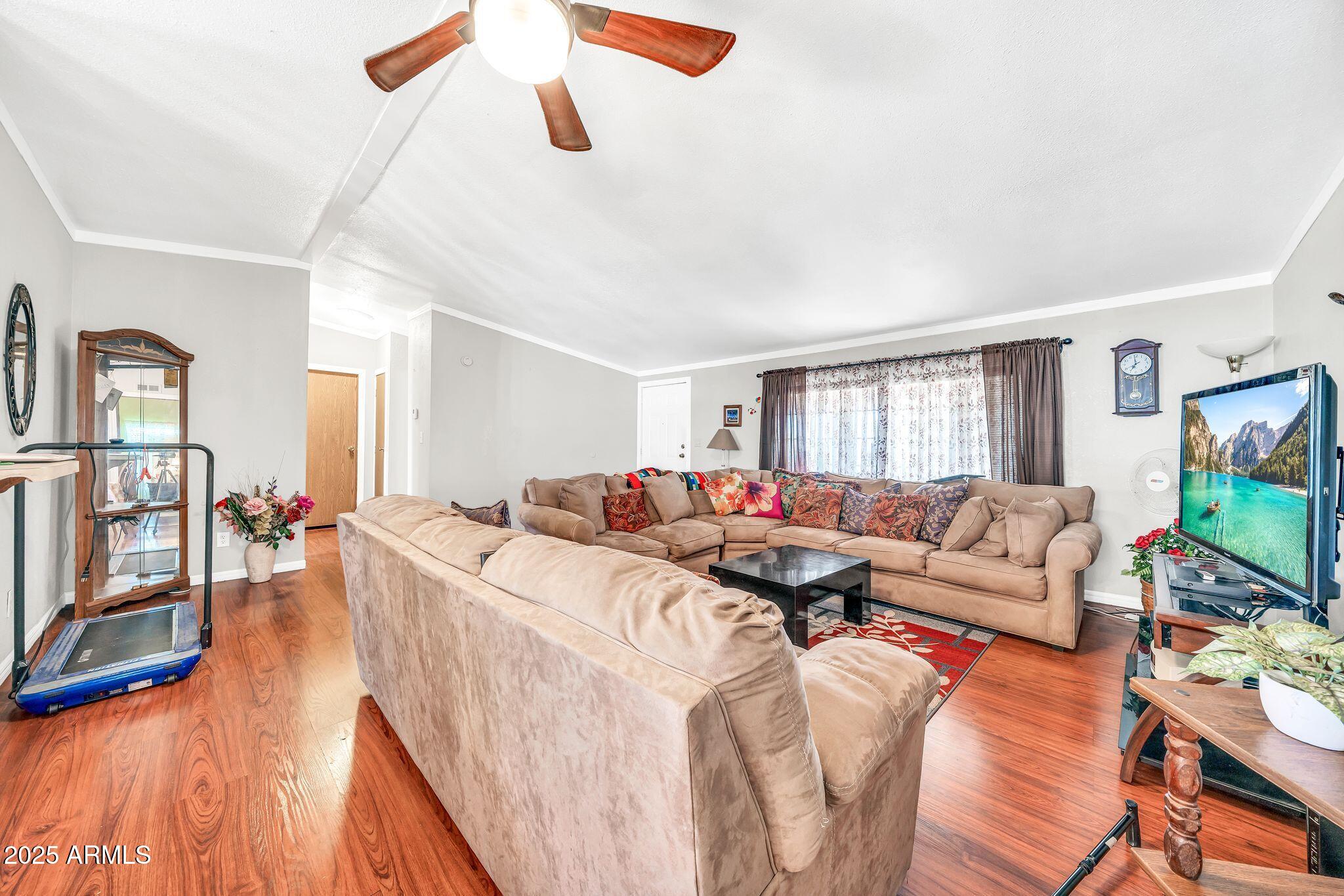 2510 East Utopia Road Phoenix, AZ 85050 - Photo 11 of 31 a living room with furniture and a flat screen tv