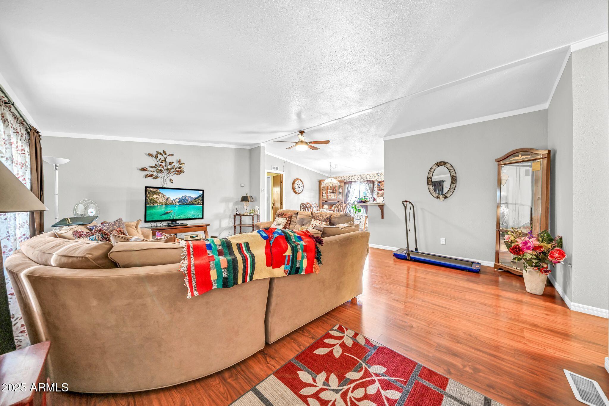 2510 East Utopia Road Phoenix, AZ 85050 - Photo 12 of 31 a living room with furniture and a flat screen tv