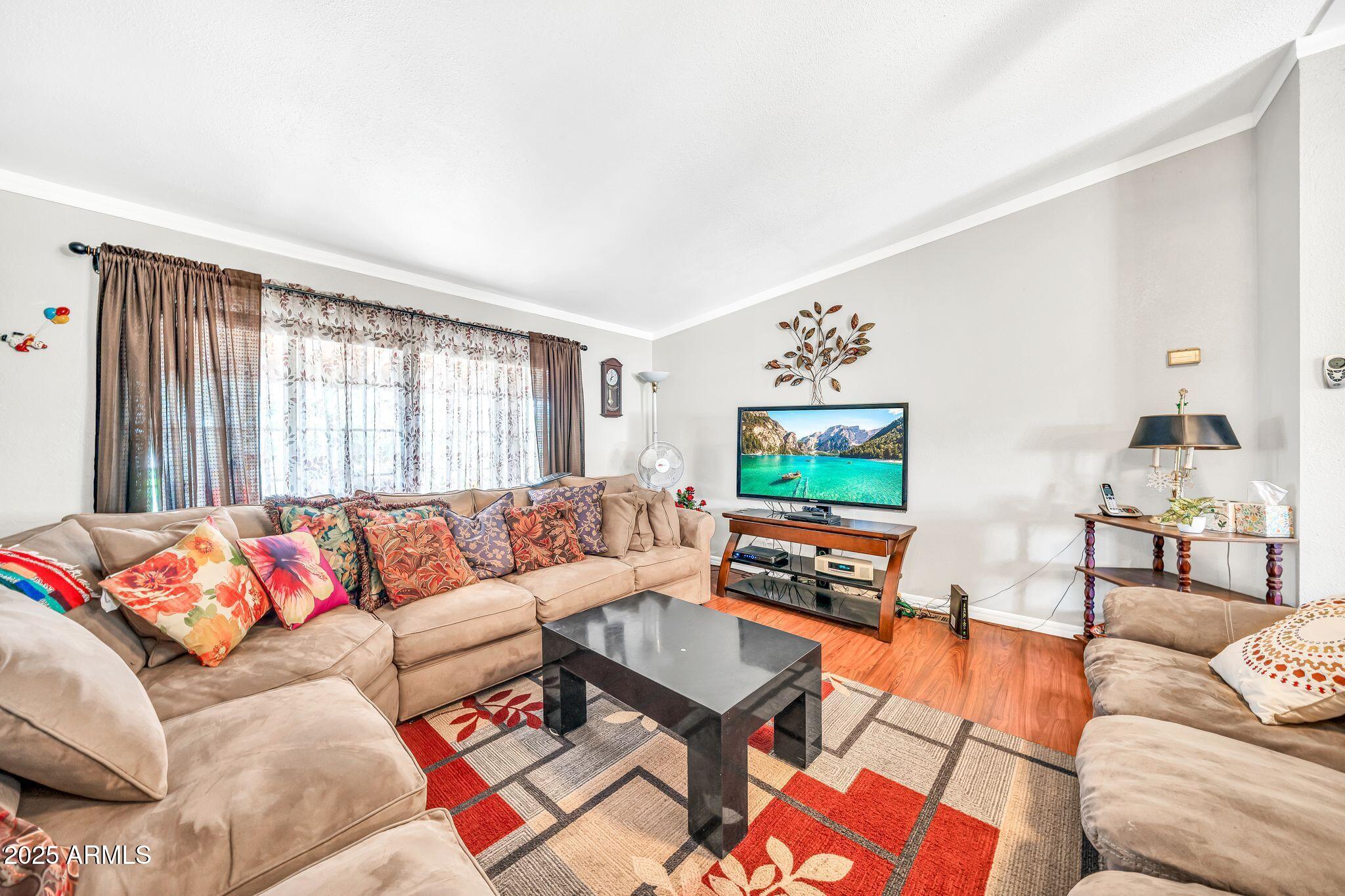 2510 East Utopia Road Phoenix, AZ 85050 - Photo 9 of 31 a living room with furniture and a flat screen tv