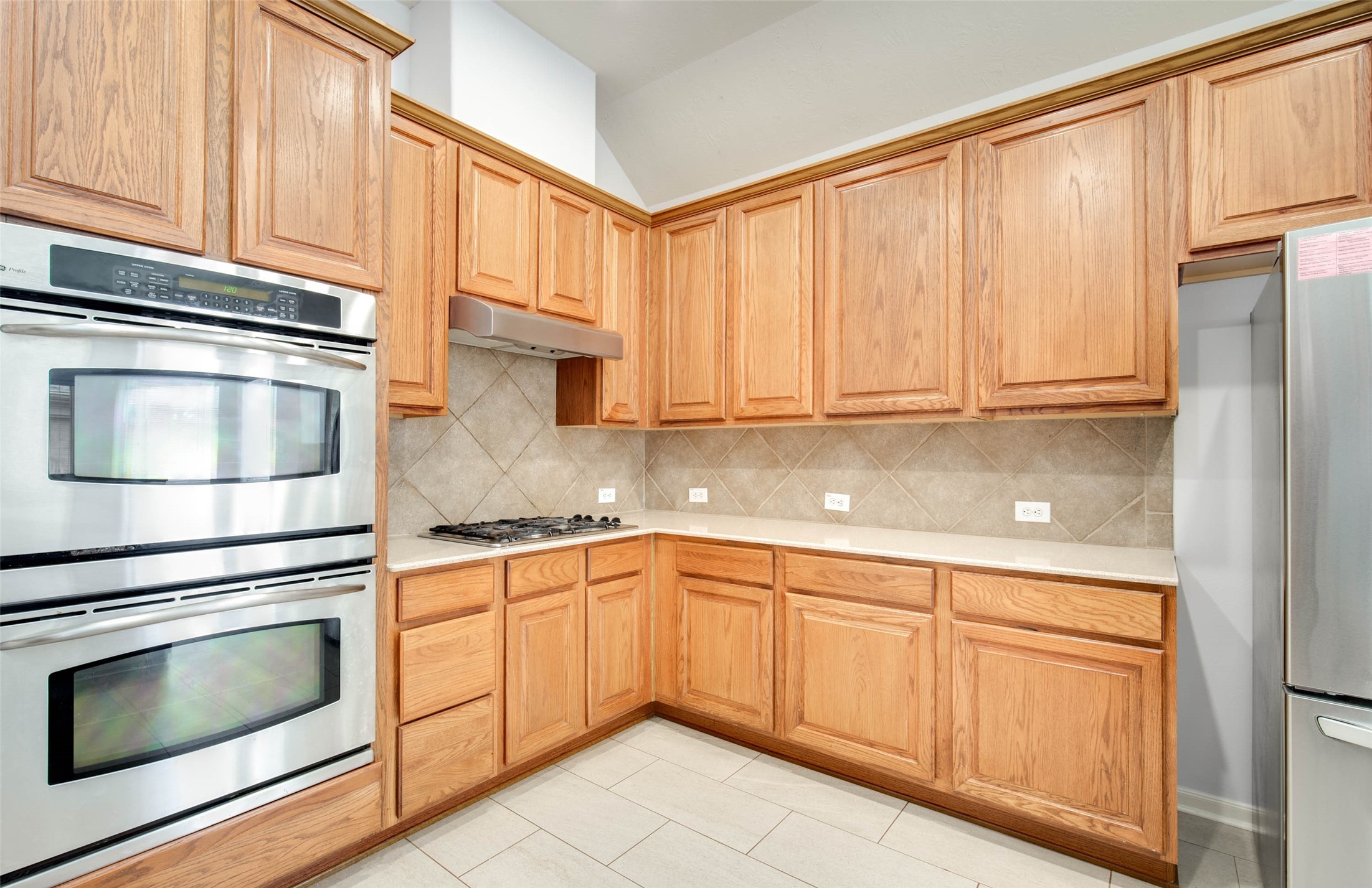 9323 Hillhaven Court Rosenberg, TX 77469 - Photo 11 of 37 a kitchen with granite countertop white cabinets and stainless steel appliances