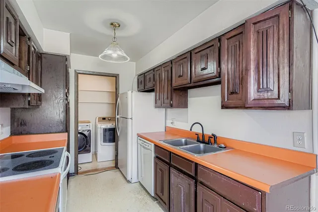 a kitchen with stainless steel appliances granite countertop a sink refrigerator and cabinets