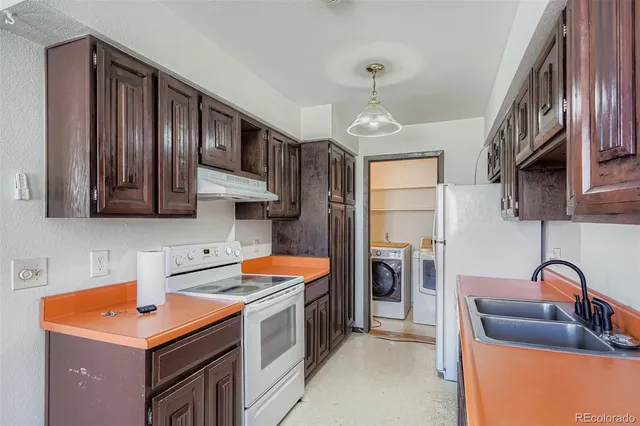 a kitchen that has a sink and a stove in it