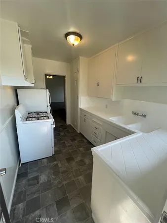 a kitchen with a sink and a stove top oven