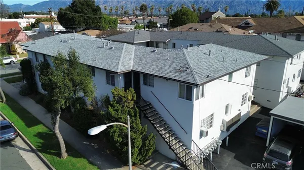 an aerial view of residential houses with outdoor space