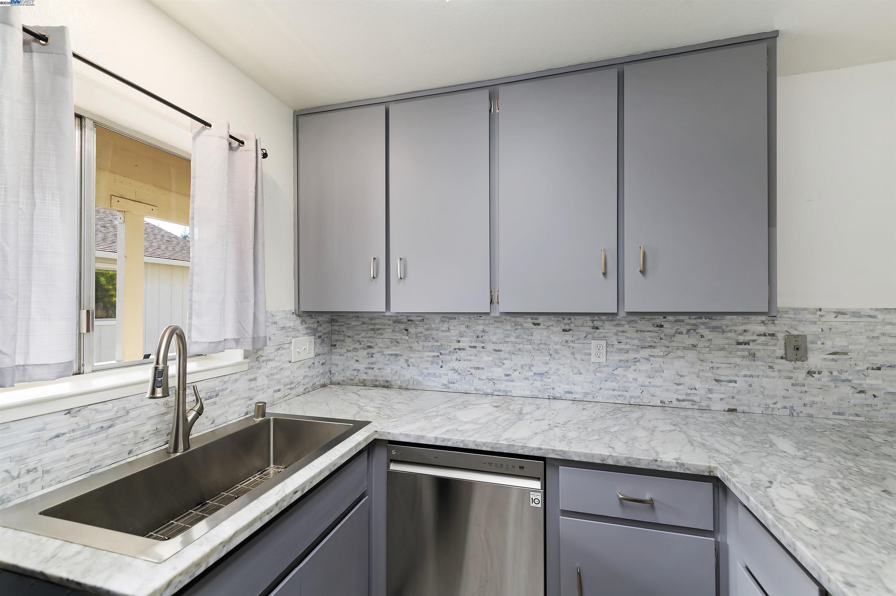 3849 Vineyard Avenue, Unit B Pleasanton, CA 94566 - Photo 11 of 21 a kitchen with granite countertop a sink and cabinets