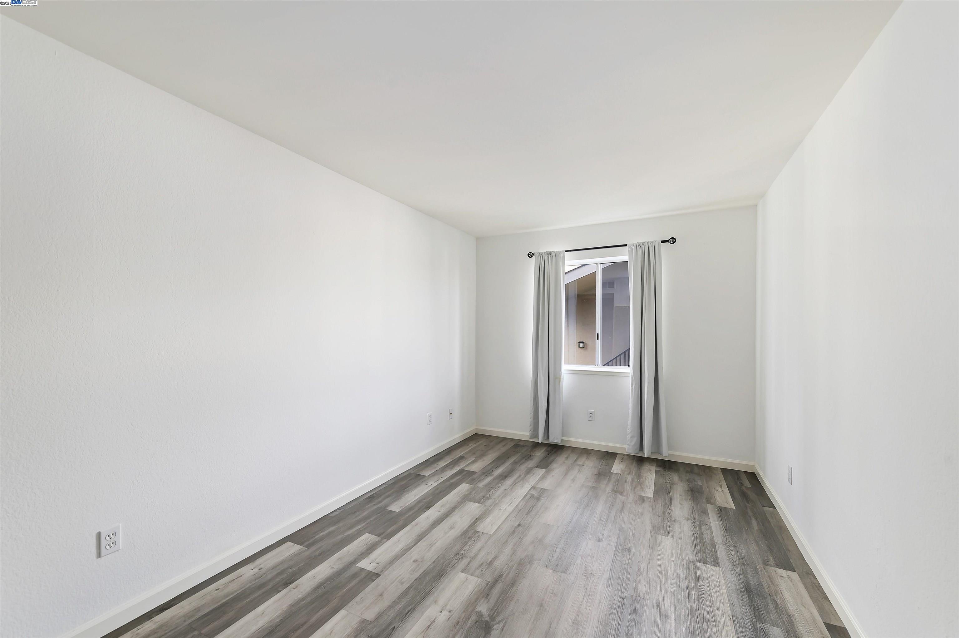 3849 Vineyard Avenue, Unit B Pleasanton, CA 94566 - Photo 14 of 21 a view of empty room with wooden floor and fan