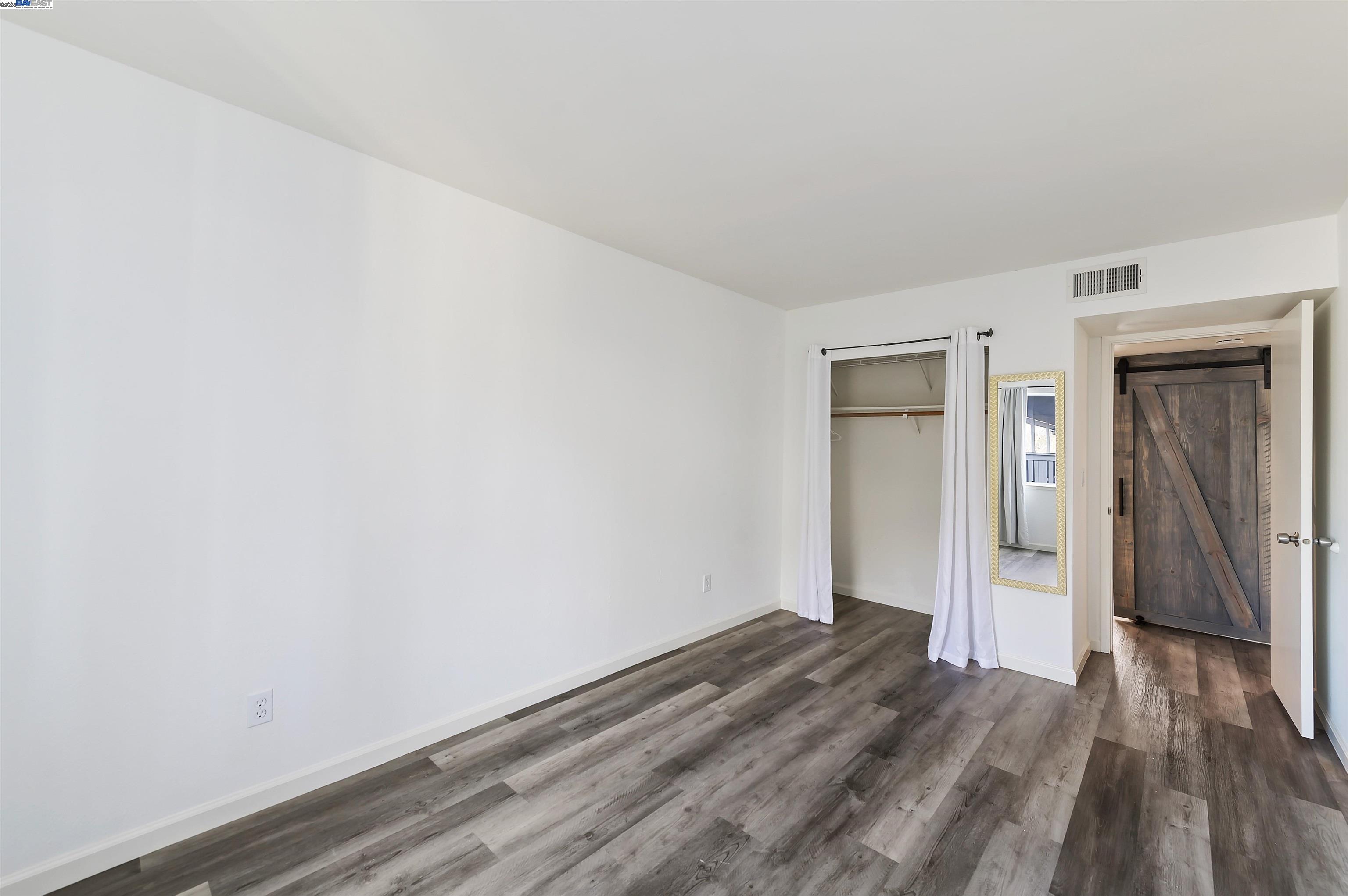 3849 Vineyard Avenue, Unit B Pleasanton, CA 94566 - Photo 16 of 21 a view of a room with wooden floor and bench