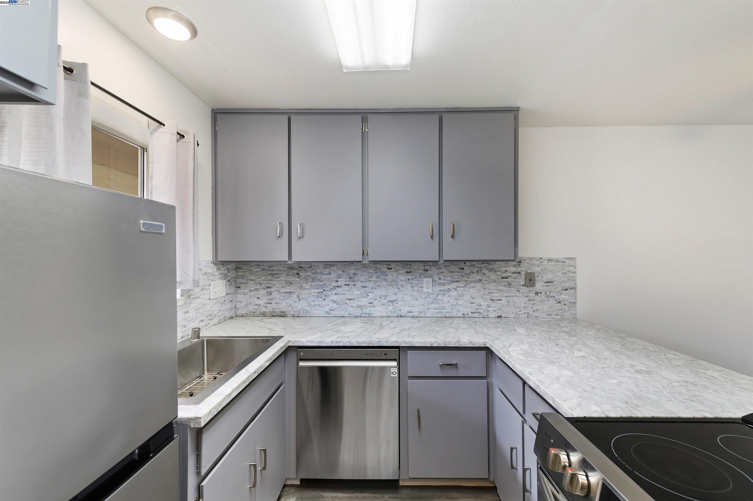3849 Vineyard Avenue, Unit B Pleasanton, CA 94566 - Photo 10 of 21 a kitchen with granite countertop cabinets stainless steel appliances and sink